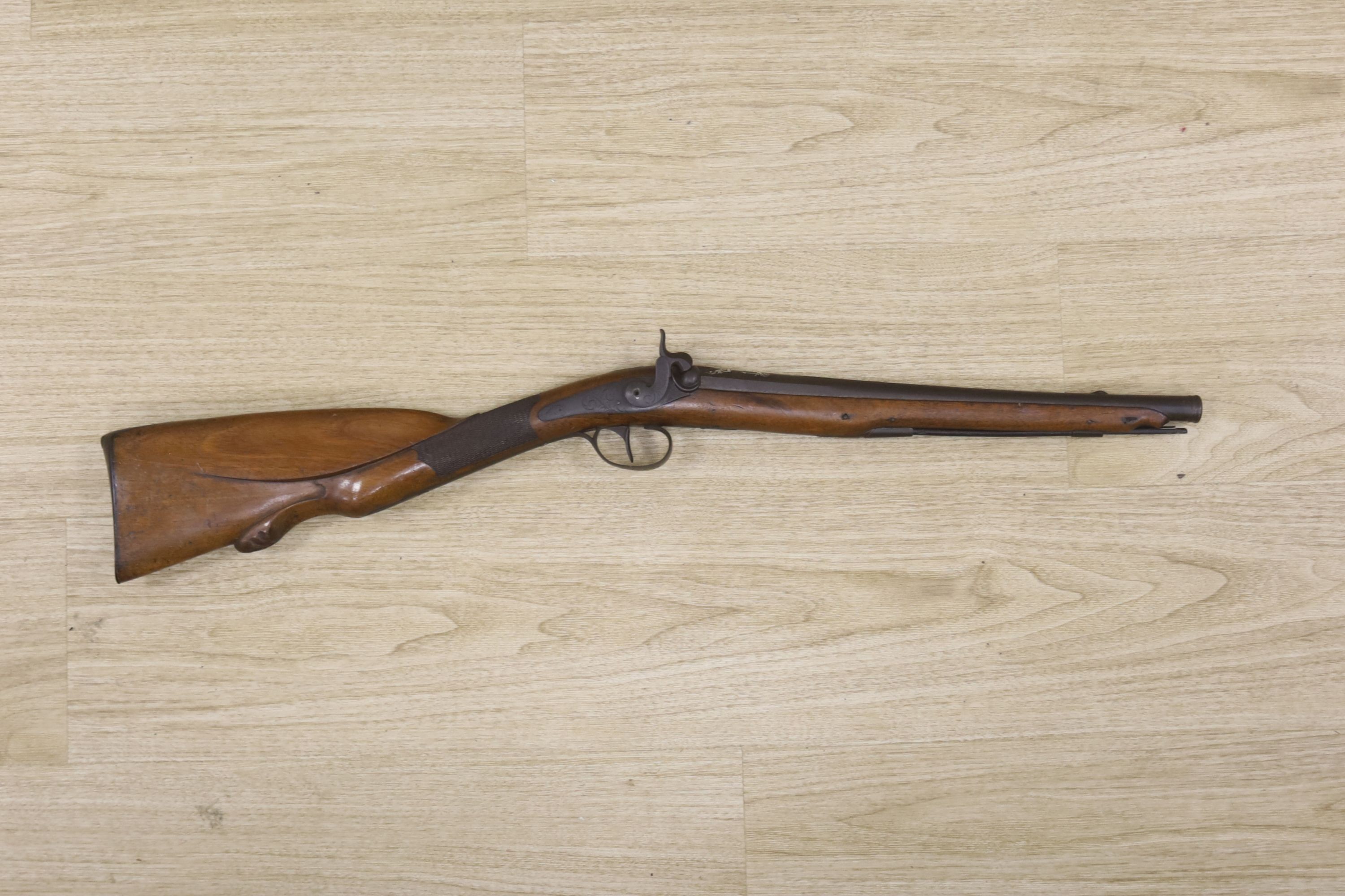 An early 19th century Belgian percussion cap carbine with carved walnut stock and silver inlaid barrel, bears indistinct mark, barrel 38cm, overall length 78cm